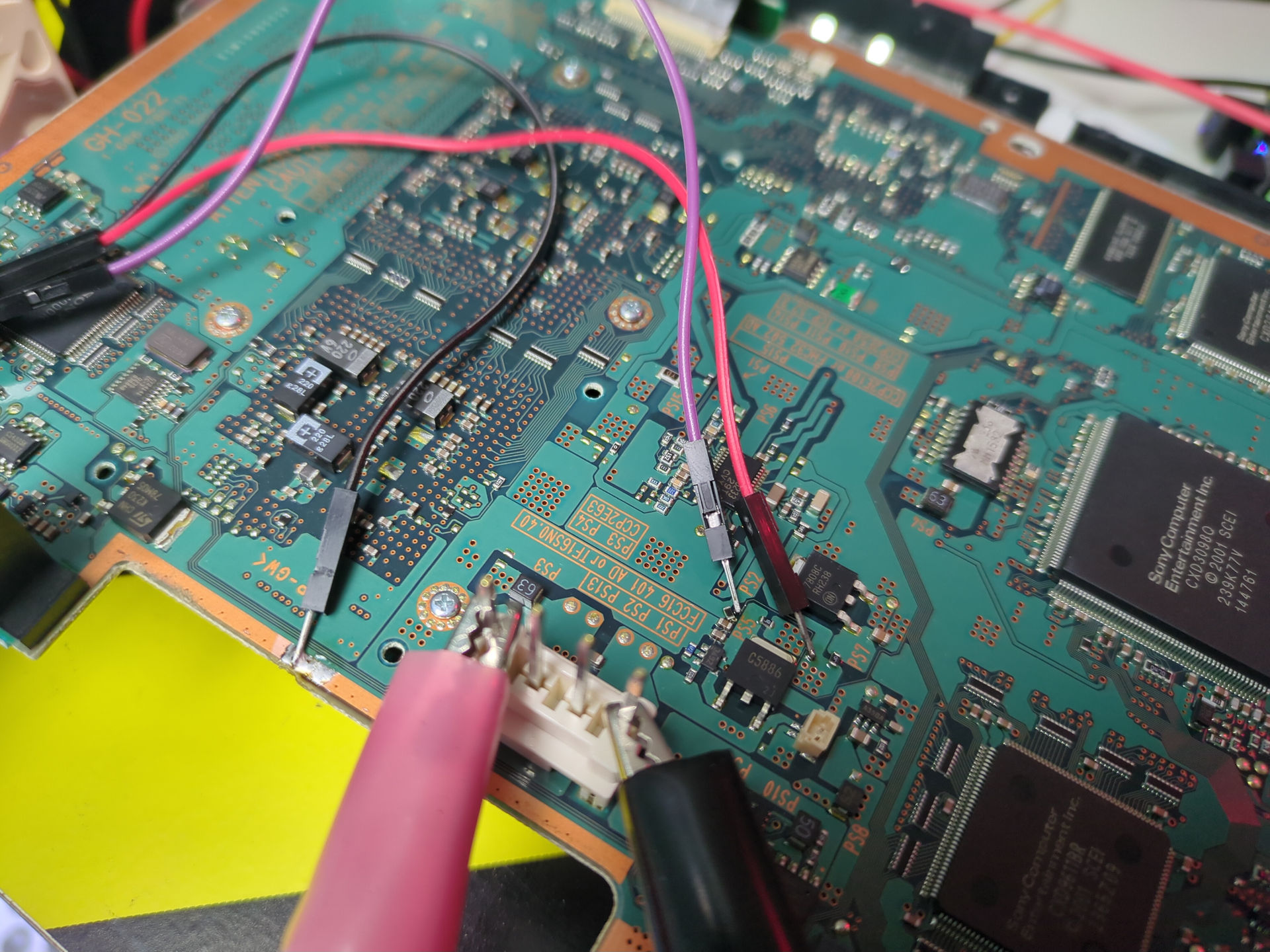 Dupont test leads soldered to a PS2 motherboard running to a fan